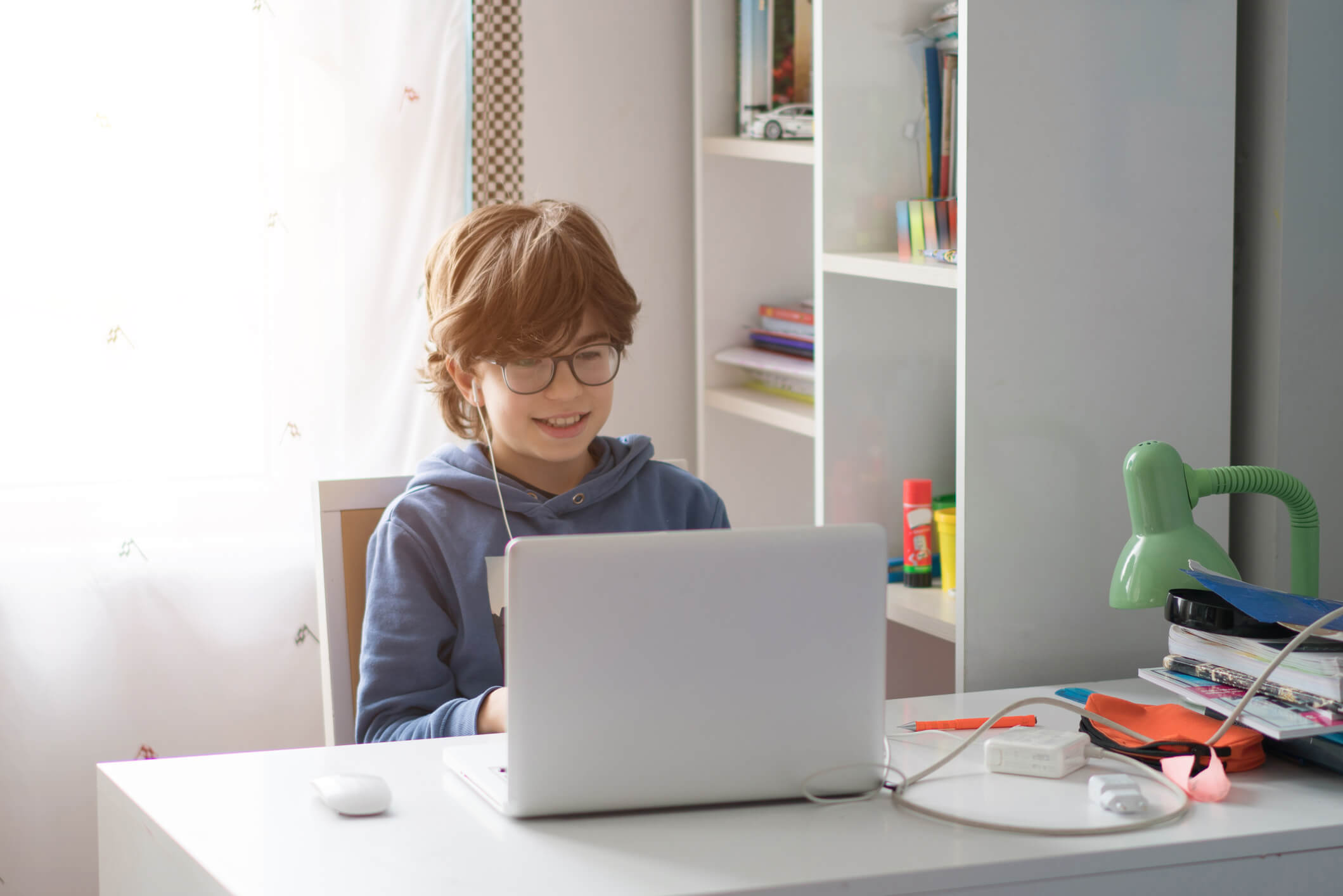 10 year old boy coding on laptop