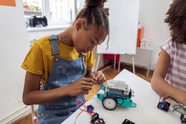 coding toys for kids - girl with makebot robotics kit