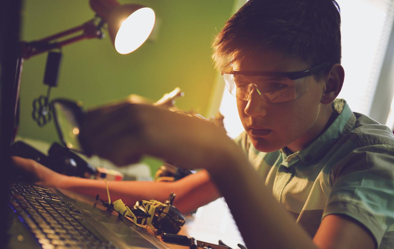 Boy building and coding a robot