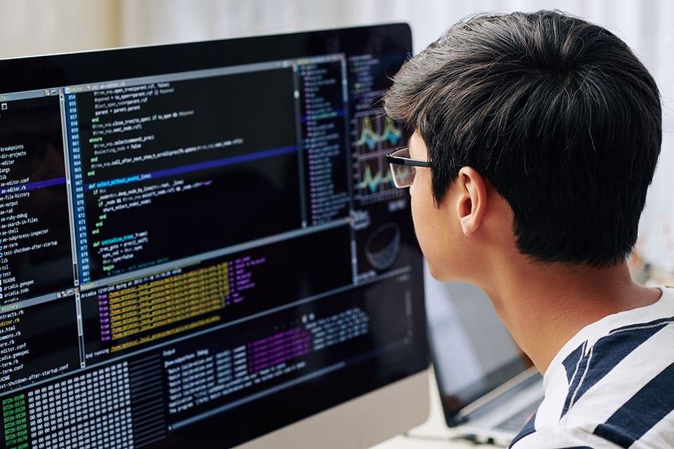 Boy programming on a computer