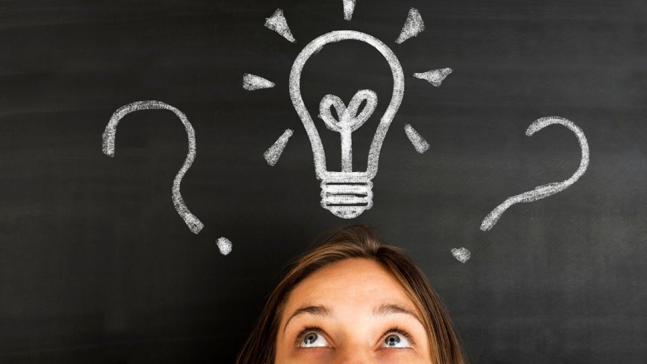 Girl thinking with chalkboard lightbulb and question marks