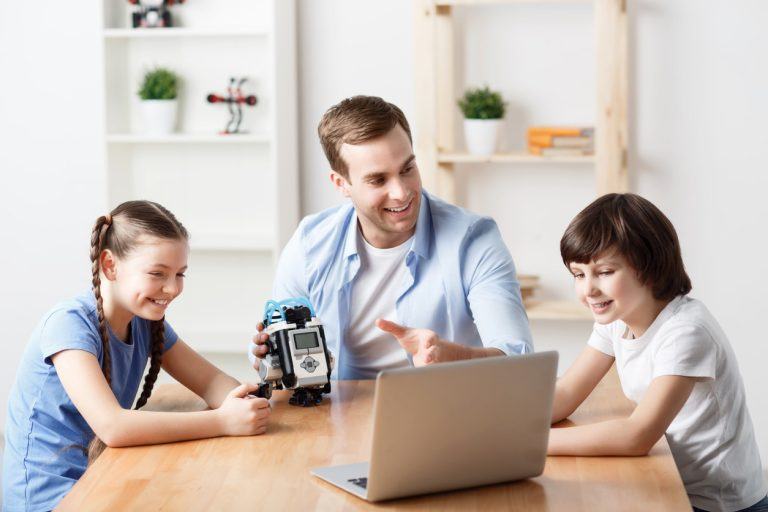 Parent teaching kids AI and robotics using a learning kit