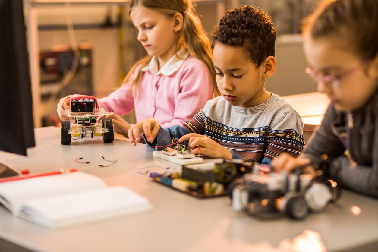 Child building a robot to learn coding and STEM skills